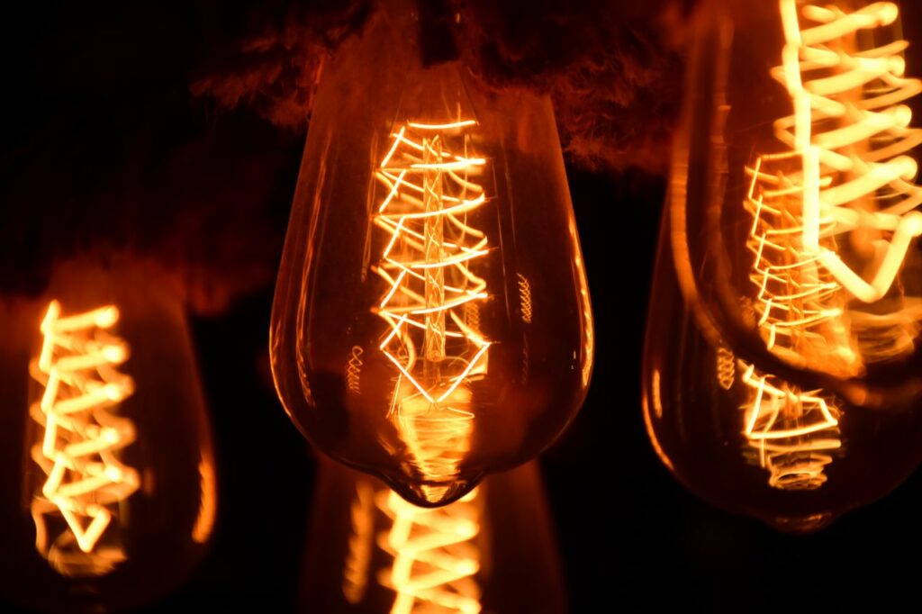 A close-up image of glowing vintage Edison light bulbs showcasing intricate filaments.